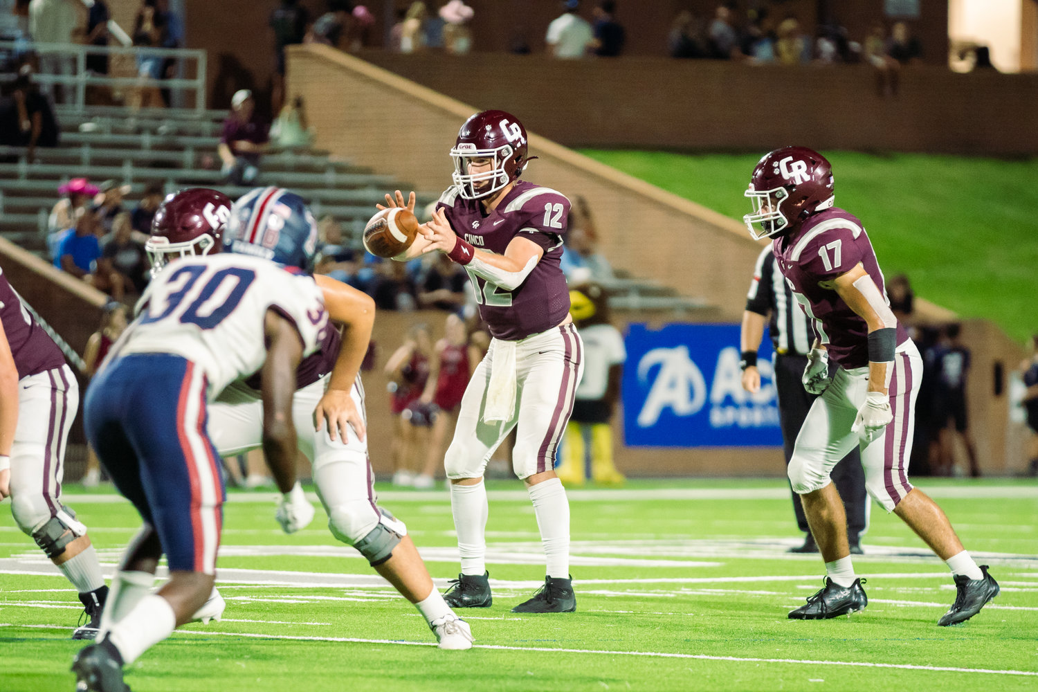 Cinco Ranch’s Gavin Rutherford takes a snap during Friday’s game between Cinco Ranch and Tompkins at Rhodes Stadium.